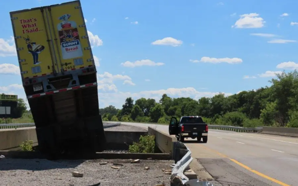 Semi runs off I-169, plunges between two bridges