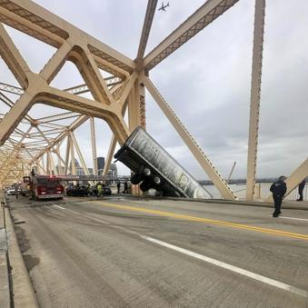 Rescue of truck driver dangling from bridge was a team effort, firefighter says